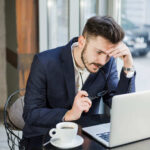 Man in thinking with Laptop - Common Invoicing Mistakes