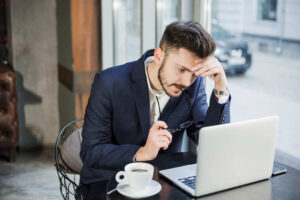 Man in thinking with Laptop - Common Invoicing Mistakes